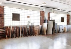 a room filled with lots of different types of tiles and wooden boards on the floor