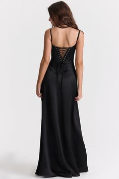 'Anabella' is perhaps our most elegant dress yet and the epitome of black tie dressing. Cut from a luxurious black silky satin for a fluid drape, 'Anabella' features a built in bra that's underwired for a flattering bust with delicate rouleau shoulder straps.The bodice has a curved hem that sits below the natural waistline and we're loving the corset inspired lace up back for a vintage feel. The skirt skims over the hips, falling freely to the floor and 'Anabella' would not be complete without tonal heels like our 'Paris' in black suede for glamorous events. The 'Regular Cup' option suits cup size A-C whilst the 'Bigger Cup' option suits cup size D-E.No bra required as it's cupped and lined.Made from heavy silky satin.Stretch Factor: 2/3 Corset Dresses Vintage Prom, Corset Dress Vintage, Witchy Birthday, Corset Back Dress, Corset Maxi Dress, Lace Corset Dress, Vintage Prom, Witchy Fashion, Lace Corset