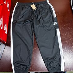 Nike Womens Black Sportswear Standard Fit Mid Rise Woven Track Pants Size Xxl Brand: Nike Department: Womens Size: Xxl Color: Black Type: Pants Style: Track Pants Pattern: Solid Theme: Sports Occasion: Activewear Season: All Season Features: Elastic Waist, Pockets Condition: New With Tags I Offer Discounts For All Return Customers. - Jvs Black Nylon Sports Bottoms, Black Bottoms With Elastic Waistband For Sports, Black Long Pants Sportswear, Nike Black Athleisure Sweatpants, Nike Black Moisture-wicking Joggers, Nike Black Moisture-wicking Sweatpants, Nike Black Joggers For Jogging, Nike Black Sweatpants For Streetwear, Black Sportswear Activewear With Elastic Waistband