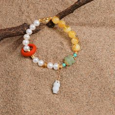 Selected natural freshwater pearl, a big full, bright color. With amber bead as an ornament, like a ray of sunshine break through the clouds. Jewelry meaning lucky, cherish, retro fashion, can be strong collocation. Elegant Pearl Bracelet With Round Natural Stones, Elegant Pearl Bracelet With Natural Stones, White Elegant Beaded Bracelets With Gemstone Beads, White Natural Stone Round Bracelets, White Natural Stone Bracelets, Hand-strung White Jade Beaded Bracelets, Spiritual Pearl Bracelet With 8mm Beads, White Jade Crystal Bracelet, White Jade Crystal Bracelet With Natural Stones