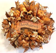 a happy thanksgiving wreath with pumpkins and ribbons