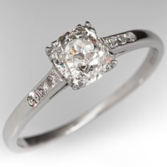 This beautiful circa 1930s diamond engagement ring is centered with one (1) old mine cut diamond weighing 0.82 carat that is set into a four-split prong setting. The shoulders of the ring are each accented with three (3), channel set, round single cut diamonds. The ring measures 6.1mm at the top, rises 4.9mm above the finger, tapering to 1.1mm wide and 0.9mm thick at the base of the shank. The ring is currently a size 7.75. One of the side diamonds has a small nick on the side that cannot be seen without magnification. Engagement Ring Platinum, Old Mine Cut Diamond, Engagement Rings Platinum, Rings Diamond, Aquamarine Jewelry, Channel Set, March Birth Stone, Jewelry Rings Engagement, High Quality Jewelry