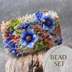 a flower arrangement is sitting on top of a piece of wood with the words bead set below it