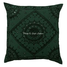 a green pillow with an ornate design on it