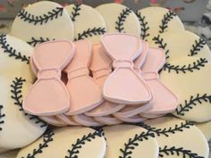 decorated cookies in the shape of baseballs and mitts are on display for people to see