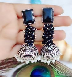 Add a touch of elegance to your bridal or party look with this stunning pair of oxidised earrings from My Jewel Box. The intricate design showcases natural pearls and stones in multiple colours, making it perfect for any occasion including engagement, wedding, anniversary, birthday or Valentine's Day. The excellent cut grade of the stones ensures maximum sparkle and glamour. Crafted from high-quality alloy and designed in Pakistan, these earrings are not only fashionable but also durable. The In Oxidized Danglers For Wedding And Diwali, Oxidized Finish Earrings For Wedding And Navratri, Silver Pearl Earrings With Stone Work For Celebration, Oxidized Jhumkas For Wedding And Navratri, Fusion Oxidized Jhumkas For Wedding, Fusion Style Oxidized Jhumkas For Wedding, Fusion Style Oxidized Finish Jhumkas For Wedding, Elegant Oxidized Chandbali Jhumkas, Silver Pearl Earrings With Stone Work For Gift