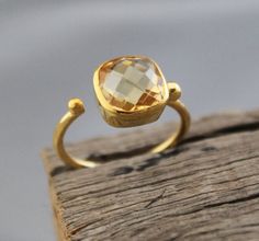 ♦♦ Beautiful handcrafted ring  ◘Stone Information:     Genuine Citrine -     Color: Yellow     Cut: Cushion briolette      Size: 10 mm  ◘ Metal: 925 Sterling Silver ◘ Band: 2 mm  ◘ Setting: Open back bezel setting ◘ Finish: High polish (shiny) ◘ Nickel free  ◘ Handmade band: 14 gauge solid sterling wire    This ring is adorably rustic, easy to wear, & stackable! ◘Please Note - The Ring in the Picture can be available or  Sold out. Every  Ring is Made of a     Unique Gemstone. Therefore, Colors a Gold Faceted Topaz Ring In Sterling Silver, Gift Rings With Yellow Sapphire Gemstone, Yellow Sapphire Gemstone Rings As Gift, Gift Yellow Sapphire Gemstone Rings, Yellow Bezel Set Jewelry For Wedding, Yellow Jewelry With Bezel Setting For Wedding, Yellow Bezel Set Wedding Jewelry, Yellow Wedding Jewelry With Bezel Setting, Faceted Yellow Topaz Ring Gift