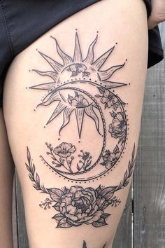 a woman's thigh with a sun and moon tattoo on it