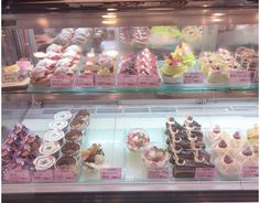 a display case filled with lots of different types of cakes