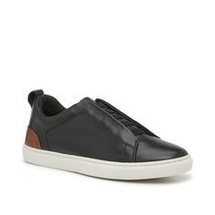 Vince Camuto-Caene Slip-On Sneaker - Men's Add to your casual collection with the Caene slip-on sneakers from Vince Camuto. The laceless design easily complements your everyday looks with ease. Complete with elastic straps for a secure fit, a leather material for a high-quality construction, and a court-inspired silhouette for a sporty touch. Casual Leather Slip-ons For Streetwear, Urban High-top Slip-on Sneakers With Contrast Sole, Black Low-top Slip-ons With Perforated Toe Box, Urban Leather Slip-on Sneakers, Masculine Black Low-top Sneakers, Slip On Sneakers, Leather Material, Black And Tan, Vince Camuto