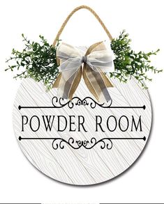 a wooden sign that says powder room with a bow on the front and back of it