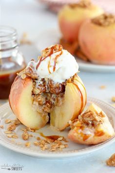 an apple dessert with ice cream and granola is on a plate next to some apples