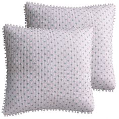 two white pillows with blue dots on them