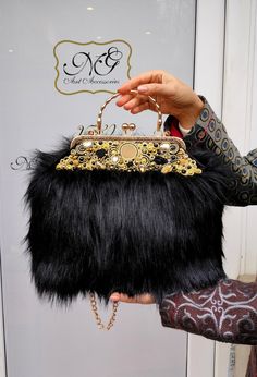 Black fur bag with soutache decoration, designer's bags. Materials: artificial fur, velvet, soutache cord The handbag is made of artificial black fur with a kiss lock and chain. The inner lining is made of velvet, with a pocket inside.  The decoration is made of Shibori ribbon, Soutache cord, colorful glass crystals, and crystals.  Size: 35x26/ (13.7x10.2 inches ) Please be aware, that the handbag is handmade, so the size is approximate and the actual product color may differ from the photos, as it depends on the gadget you use and the colors of the monitor of your gadget.  If you want to be extraordinary and outstanding from all of the others, or if you want to make a unique gift for your loved ones, then this handbag is an excellent choice!! Shibori Ribbon, Faux Fur Handbag, Purse Outfit, Faux Fur Purse, Fur Handbags, Fur Bag, Bags Luxury, Black Faux Fur, A Kiss