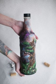 a person holding a bottle with an image on it