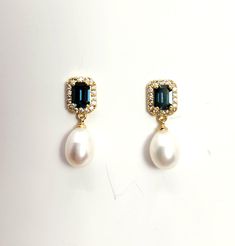 6mm white or cream swarovski round pearl drop with emerald rectangle cut Montana navy blue crystal rhinestone gold or rhodium silver plated post earrings. Size: 1.4cm x 7cm Returns and exchange details   Customer Satisfaction Guarantee: Below policy will replace standard ETSY policy- please read carefully before purchasing. If you are not satisfied with an item for any reason, I will provide a full refund less the actual shipping and handling charge (usually around $4.00). The return or exchange request must be made within 3  days from the actual delivery date. All returns must be postmarked within 3 business days of receiving a return authorization. Please contact me via Etsy convo only. I do not accept return/exchange authorization requests after 3 days from receipt of shipment and do no Elegant Rectangular Cubic Zirconia Earrings, Elegant Rectangular May Birthstone Earrings, Elegant Rectangular Emerald Earrings For May Birthstone, Elegant Blue Emerald-cut Jewelry, Elegant Emerald Cut Earrings, Elegant Pearl Gemstone Earrings For Formal Occasions, Formal Oval Earrings With Pearl Charm, Elegant Oval Jewelry With Pearl Charm, Exquisite Rectangular Formal Jewelry