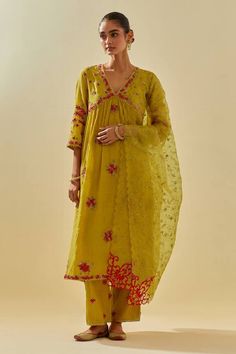 Yellow anarkali featuring floral silk applique clustered motifs embellished with sequins. Comes with embellished pant, scalloped hem dupatta and inner slip. - Aza Fashions V-neck Traditional Wear With Resham Embroidery In Chanderi, Anarkali Set With Floral Embroidery In Tissue Silk, Yellow Chanderi Churidar With Floral Embroidery, Bollywood Floral Embroidered Anarkali Set, Bollywood Style Floral Embroidered Anarkali Set, Bollywood Style Pista Green Salwar Kameez With Floral Embroidery, Bollywood Style Pista Green Palazzo Set With Floral Embroidery, Traditional Anarkali Set With Floral Embroidery In Tissue Silk, V-neck Salwar Kameez With Chikankari Embroidery For Diwali