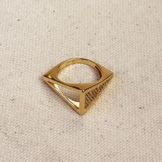 Make a statement with this unique and gorgeous 18k Gold Filled CZ Geometric Ring. Its intricate design and sparkling Cubic Zirconia stones will surely catch everyone's eye. Elevate any outfit and add a touch of elegance with this statement piece! Metal: 18k Gold filled High-quality Cubic Zirconia AAAAA Available sizes: 5.5, 6.5, 7, 8 and 9 Hypoallergenic Water-resistant Handcrafted in Brazil Also available our Triangle Stud Earrings to complete your outfit. Triangle Stud Earrings, Triangle Ring, Triangle Earrings Stud, Triangle Studs, Ear Stack, Geometric Ring, Intricate Design, Cleaning Clothes, Geometric Design