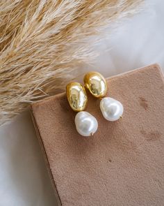 Make a timeless statement with these chic Hailey Dome Pearl Drop Earrings! Crafted in gold and featuring an elegant pearl, these earrings will be a beautiful addition to your collection. Slip them on for a sophisticated finish to any look! EARRINGS FEATURE Material: Brass, Shell Teardrop Pearls Finish: 14K Gold Filled Size: 17.9mm x 11.8mm x 18.9mm, Pearl Size 10mm x 12mm Lead & Nickel-Free Wedding Day Pearl Earrings, Wedding Earrings Bride, Business Vision, Statement Earrings Wedding, Dainty Engagement, Brass Shell, Bridal Jewels, Dainty Engagement Rings, Jewel Wedding