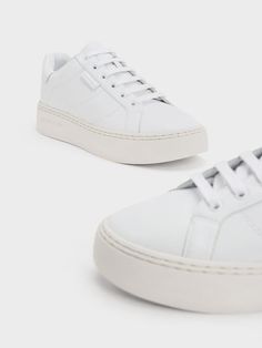 This product is made with at least 20% sustainable materials by weight. CHARLES & KEITH uses recycled, degradable, organic, and water-based materials in our eco-conscious collection. Every fashion girl needs a pair of white sneakers in her shoe collection. Equipped with sturdy and comfortable platform soles, these sneakers offer both day-long comfort and a subtle height elevation. A closer examination reveals the intricate stitch-trim lining and our branded logo etched on the side, providing an added layer of visual detail. Girl Needs, Charles Keith, Eco Conscious, Fashion Girl, Sustainable Materials, White Sneakers, Sneakers White, Shoe Collection, White Lace