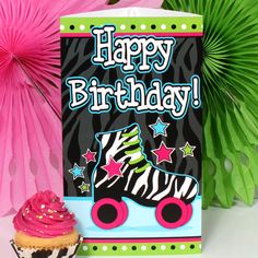 a birthday card with a zebra roller skate and cupcake on the table next to it