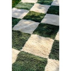 a green and white checkered rug on the ground