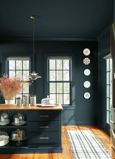 a kitchen with black walls and wooden floors