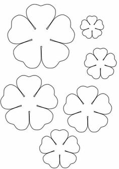 four leaf clovers cut out to make the shape of shamrocks for st patrick's day