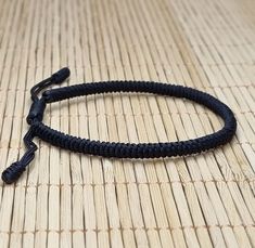 "◾ The handmade black Tibetan bracelet for luck and protection is a beautifully crafted accessory, each knot is meticulously tied whos creates an amazing pattern. ✅ Adjustable bracelet - the slip knot lets you adjust the size. ➰ Sizes: S - Fully Closed - 5.9\"inches (15cm) / Full Opened - 9.8\"inches (25cm) M - Fully Closed - 6.6\"inches (17cm) / Full Opened - 10.6\"inches (27cm) L - Fully Closed - 7.4\"inches (19cm) / Full Opened - 11.4\"inches (29cm) ⬛ The color of the bracelet is black. ◽ More colors and models are available in the shop. ◽ Just check out the shop. ✔️ Please note that due to the difference between different monitors, the image may not reflect the actual color of the item. ✍ If you have any questions please contact me." Handmade Black Nylon Cord Bracelets, Handmade Adjustable Nylon Thread Bracelets, Handmade Adjustable Nylon Thread Bracelet, Adjustable Black Paracord Braided Bracelet, Resizable Nylon Cord Braided Bracelets, Handmade Black Paracord Braided Bracelet, Handmade Minimalist Bracelets With Nylon Cord, Snake Knot Bracelet, Snake Knot