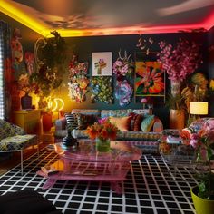 a living room filled with lots of colorful furniture and flowers on the wall behind it