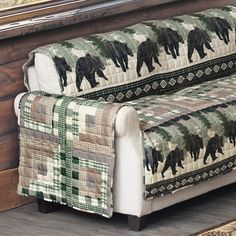 a living room with a couch and rugs on the floor