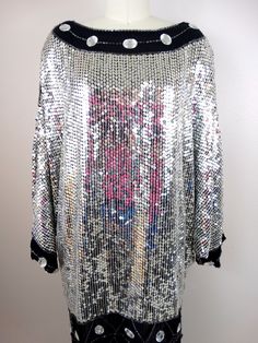 "This beautiful vintage piece fully embellished with reflective mirror silver sequins and jewels on silk and fully lined. It's in excellent condition! (note, I was wearing a pink shirt while photographing and the color reflects in the sequins) Bust - 58\" Waist - 44\" Hips - 42\" Length - 34\" All of my items come from a smoke-free and pet-free home. If you have any questions, please don't hesitate to ask!" Silver Embellished Sequin Fabric For Night Out, Holiday Silver Embellished Sequin Dress, Silver Embellished Sequin Dress For Holiday, Disco Style Embellished Sequin Cocktail Dress, Disco Style Embellished Sequin Fabric For Party Season, Metallic Embellished Sequin Dress For Cocktail, Holiday Metallic Embellished Sequin Dress, Embellished Silver Sequin Fabric For Party Season, Silver Embellished Sequin Fabric For Party Season