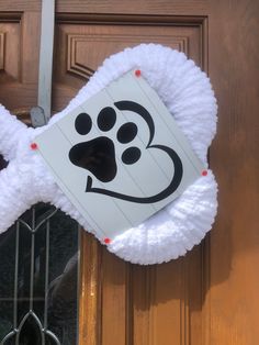 a door hanger with a dog's paw on it