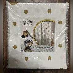 the package is wrapped in plastic and has gold polka dots on it, along with an image of mickey mouse