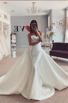 a woman taking a selfie in her wedding dress