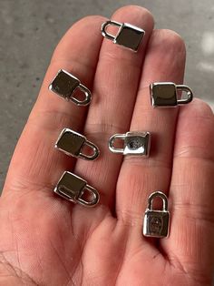 a person holding several metal clips in their hand