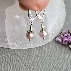 "✦These dainty earrings are a perfect little girl gift for a Daddy's gift or for a woman for everyday wear.  They are lightweight and easy to wear! ✦Small, dainty round-shaped natural pink freshwater pearl, 6mm in diameter, with sterling silver flower bead caps. ✦Ear wires: The oxidized silver version comes with stainless surgical steel lever back ear wires and the bright silver pair comes with sterling silver ear wires. Please select bright silver or oxidized silver at check out. ✦The total length is about 1 inch.  ✦Your jewelry will be packaged in a beautiful and reusable organza bag. All items will be placed in the same organza bag. If you need a separate bag for each item, please leave a comment at check out. ✦Giving your purchase as a gift? If you would prefer that prices not be print Tiny Elegant Pearl Earrings For Gifts, Gift Pearl Drop Earrings With Lever Back, Teardrop Pearl Earrings With Lever Back For Gift, Hypoallergenic Pink Pearl Earrings As Gift, Hypoallergenic Pink Pearl Earrings For Gift, Gift Pearl Dangle Earrings With Lever Back, Pearl Dangle Earrings With Lever Back For Gift, Delicate Hypoallergenic Pearl Earrings As Gift, Delicate Pink Pearl Earrings For Gift