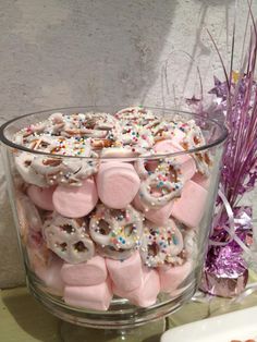 a glass bowl filled with marshmallows and sprinkles