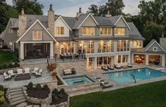 an aerial view of a large home with a pool and hot tub in the yard