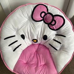 a pink and white hello kitty seat cushion