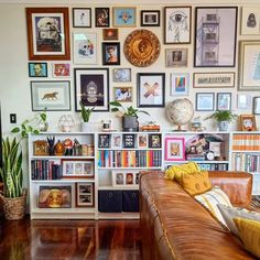 a living room filled with furniture and lots of pictures on the wall