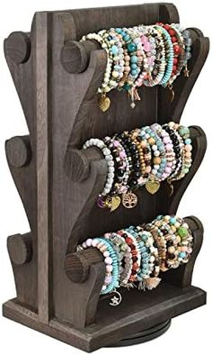 a wooden rack with bracelets on it