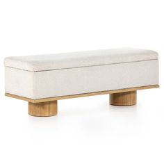 a white bench sitting on top of a wooden base