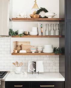 the shelves in this kitchen are filled with dishes