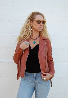 A Mauritius signature. Crafted from 100% leather our super soft tumbled jacket with fringes on the arms is both statement making and classic. 3 Front Zipper Pockets, Fringe Detailing, Button Collar Total Length - 20" Runs Small Distressed Leather Biker Jacket For Fall, Chic Leather Jacket With Fringe For Fall, Leather Fringe Outerwear For Fall, Long Sleeve Biker Jacket With Fringe For Spring, Fall Leather Jacket With Fringe For Rodeo, Fall Leather Outerwear With Fringe, Spring Biker Jacket With Fringe, Chic Leather Jacket With Fringe, Spring Fringe Biker Jacket