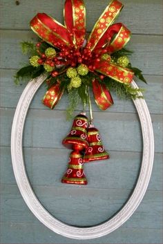 a christmas wreath with bells hanging from it