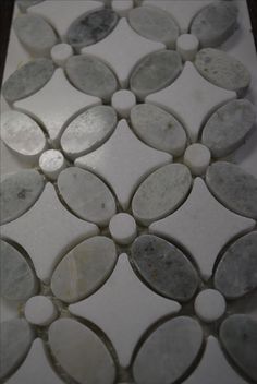 a white and grey tile with circles on it