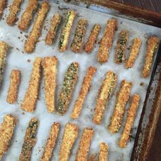 some food is laying out on a baking sheet and ready to be cooked in the oven