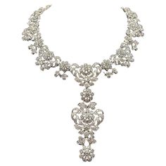 Elevate your jewelry collection with this exquisite Edwardian diamond necklace, meticulously crafted from 18-kt white gold. This custom vintage piece boasts an impressive 35.97-carats of diamonds, radiating timeless elegance and sophistication. The necklace features a detachable centerpiece pendant, allowing versatile styling options to suit any ensemble. Luxury Elegant Filigree Diamond Necklace, Luxury White Gold Diamond Necklace With Intricate Design, Opulent Diamond Necklace With 17 Jewels, Opulent Diamond Necklace For Formal Events, Opulent Diamond Necklace For Formal Occasions, Luxury Diamond White Crystal Necklace, Formal Silver Diamond Chain Necklace, Exquisite Crystal Diamond Necklace With Single Cut Diamonds, Luxury Silver Diamond Necklace With Single Cut Diamonds