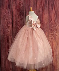 Our enchanting Ankle Length flower girl dresses are sure to turn heads! Bodice is made of Blush satin, waist consists of a matching sowed in sash (NOT DETACHABLE) The back of the dress has an open deep V-Back with a hidden zipper, followed by a detachable bow. The skirt has 4 tulle layers for fullness, the top layer of tulle consists of pearls. The dress has 2 layers of lining with crinoline. This dress is perfect for any occasion!  Dress Is Pictured with a petticoat NOT INCLUDED https://www.etsy.com/listing/1305138635/white-ankle-length-petticoat-wedding?click_key=50d449c187c9e82c565249da914d7ed38b32b9f7%3A1305138635&click_sum=17db9314&ref=shop_home_active_2 Visit our store, more items to come!  https://www.etsy.com/shop/LittledarlnBoutique?ref=profile_header CUSTOM MEASUREMENTS AVAILABLE Satin Princess Dress For Dress-up, Satin Princess Bridesmaid Dress, Princess Satin Bridesmaid Dress, Princess Style Satin Bridesmaid Dress, Pageant Tulle Ball Gown With Satin Bow, Sleeveless Satin Princess Wedding Dress, Princess Style Pink Bridesmaid Dress For Pageant, Pink Fitted Satin Princess Dress, Pink Bridesmaid Dress For Pageant